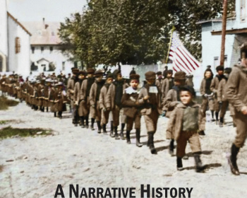 Cover of the book "Michigan Indian Boarding School Survivors Speak Out: A Narrative History" by Sharon Marie Brunner, MSW, featuring a historical photo of children walking in a line with an American flag, and houses in the background.